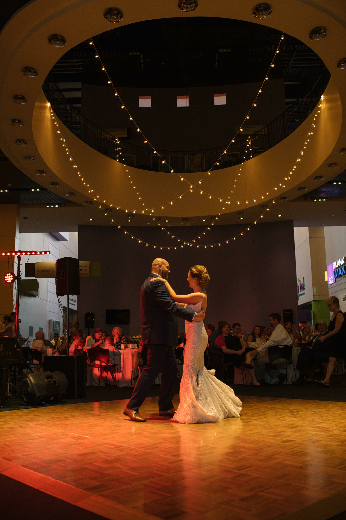 Couple on their wedding day during their first dance at the Science Center of Iowa