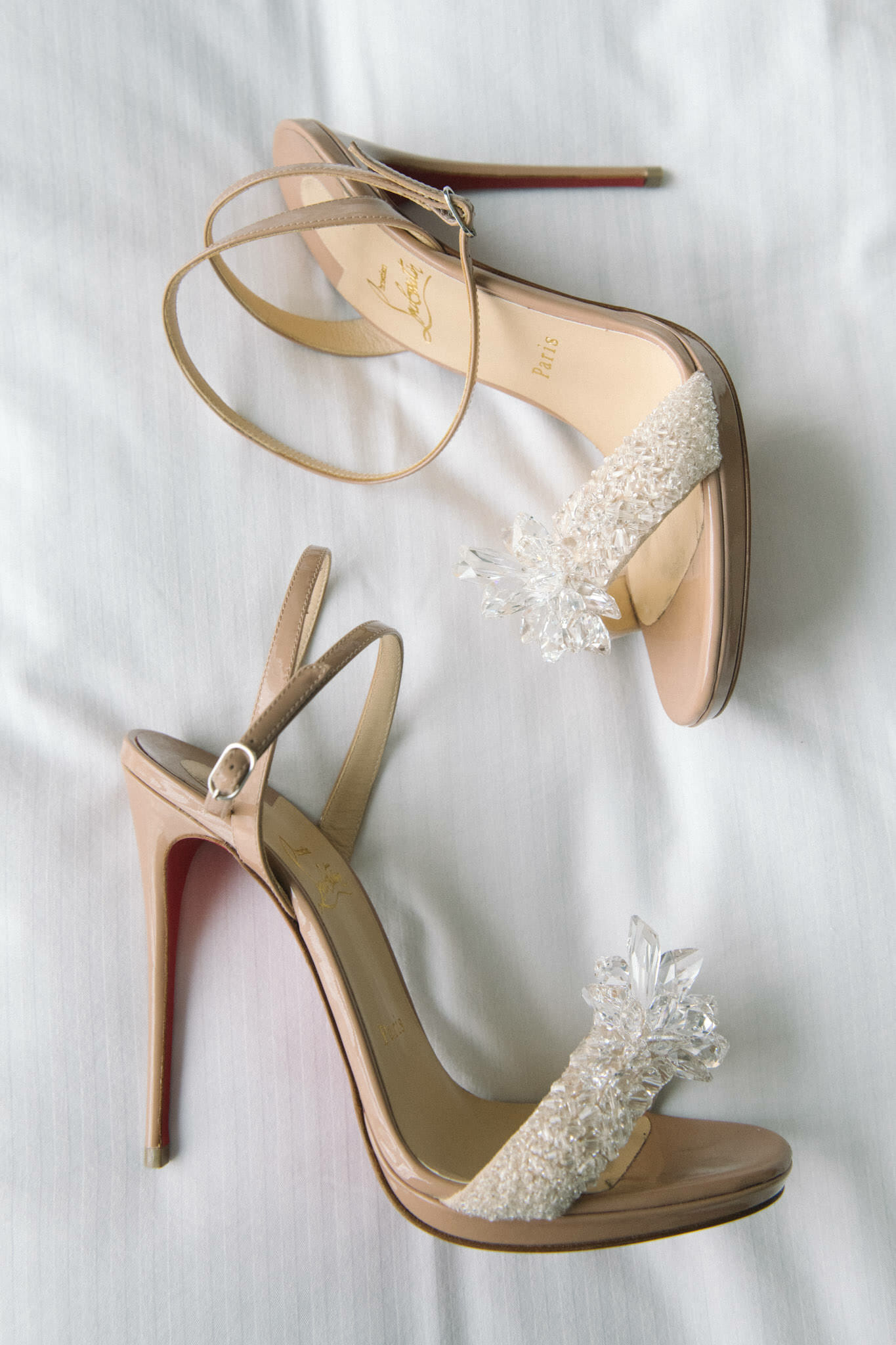Beautiful crystal Christian Louboutin shoes down on a beautiful white dress