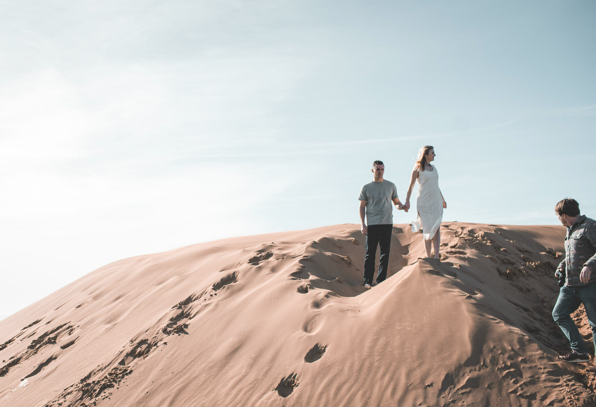 couple being photographed on sand dunes just outside of San Luis Obispo