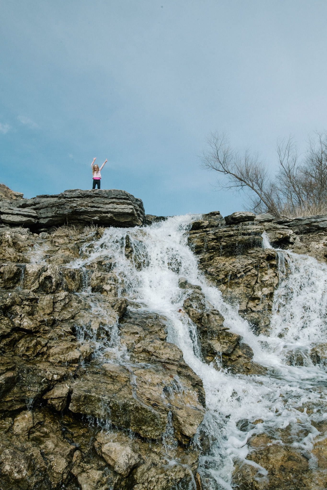 Gwen Meyer standing on top of a waterfall