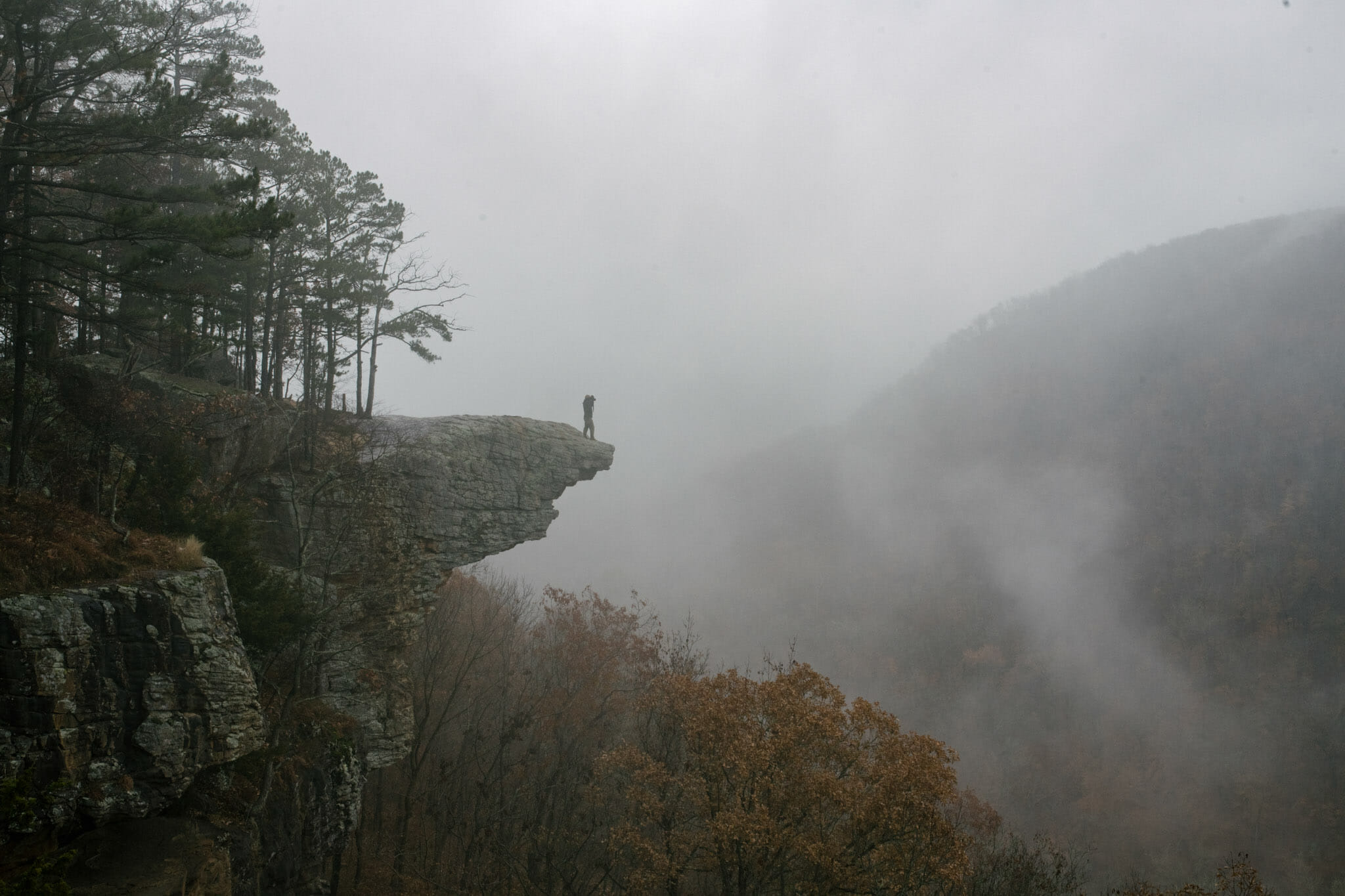 Man standing at the edge of Hawksbill Crag in Arkansas