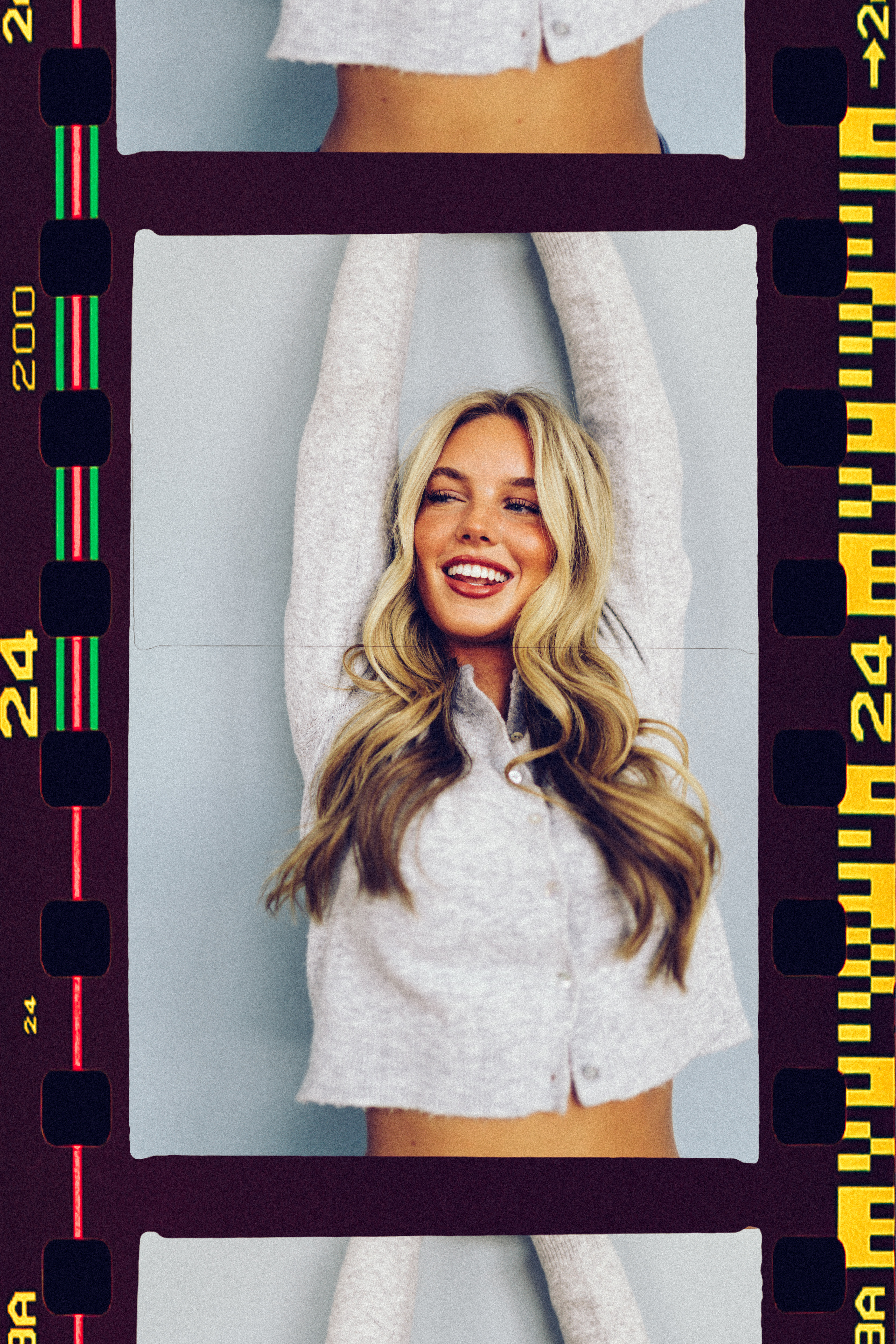 a woman with long blonde hair and a white shirt with her arms up