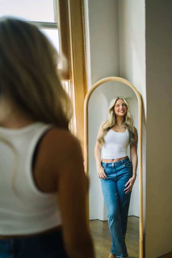 a woman looking at herself in a mirror