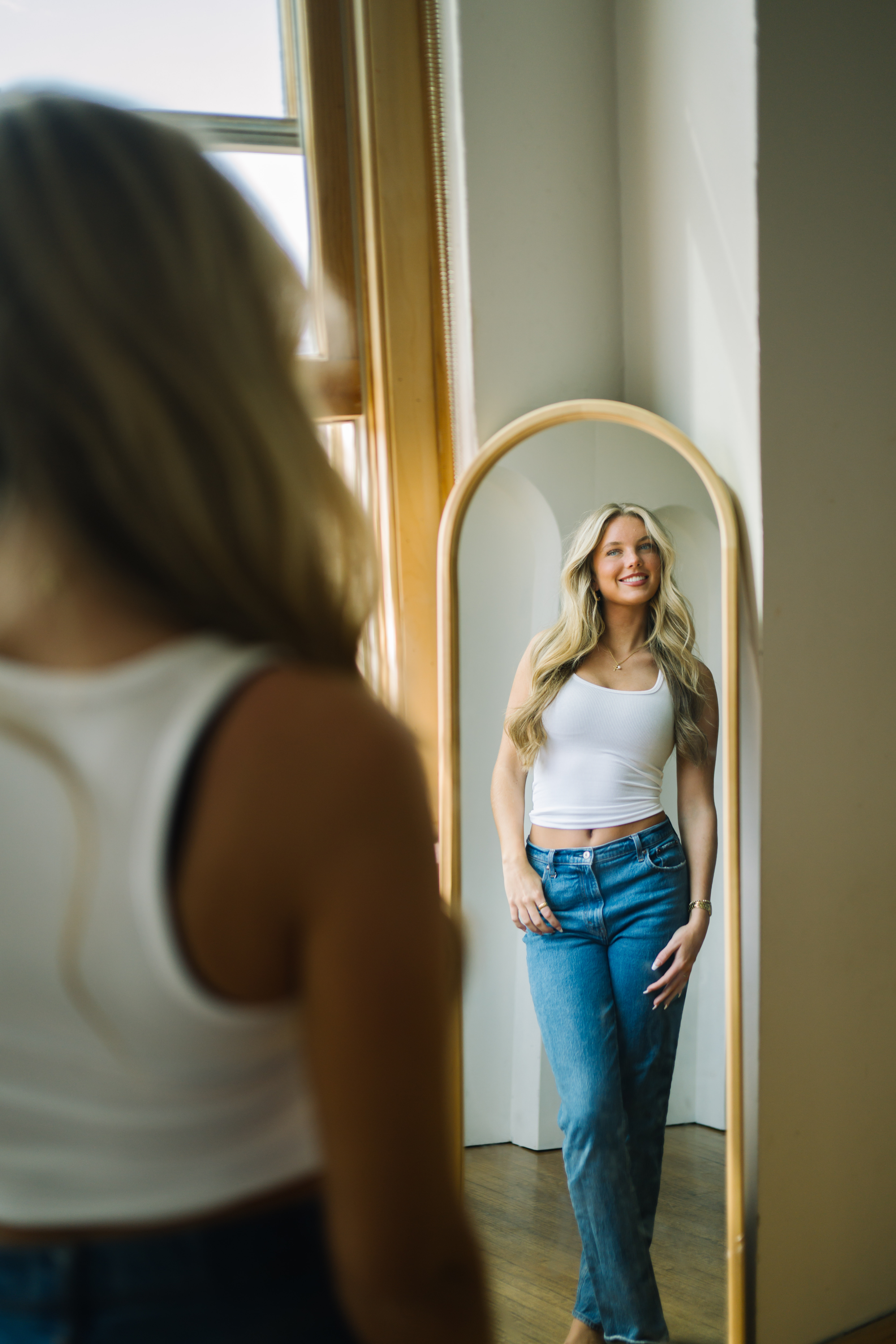 a woman looking at herself in a mirror